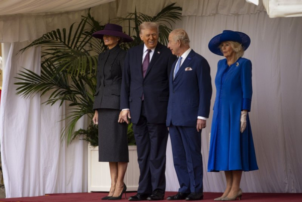 U.S. President Donald Trump (C-L) and King Charles (C-R), flanked by First Lady Melania Trump (L) and Queen Camilla (R), share a joke as they review a Guard of Honour at Windsor Castle on Wednesday. Photo by RAF Sgt. Rob Kane/Defense Ministry/EPA