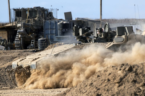 An Israeli armored personnel carrier enters a military staging area inside Israel, along the border with the Gaza Strip, on Friday. Photo by Jim Hollander/UPI
