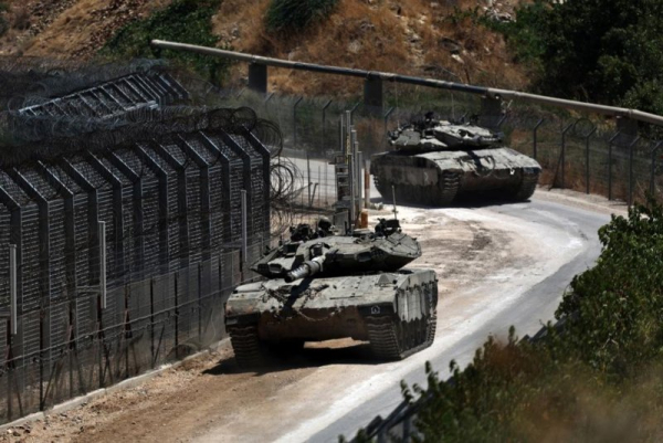 Israeli soldiers patroll at the cease-fire line, near the Israeli-annexed Golan Heights village of Majdal Shams in July. File Photo by Atef Safardi/EPA