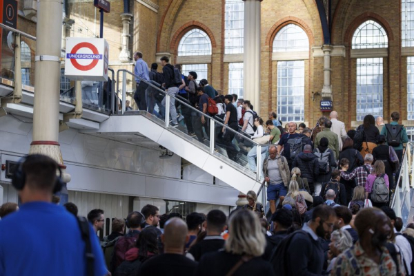 Commuters who would normally be speeding toward their destinations in subway cars deep beneath London file out of Liverpool Street station Monday in search of alternative transport amid a strike by London Underground staff that brought travel chaos to the capital. Photo by Tolga Akmen/EPA
