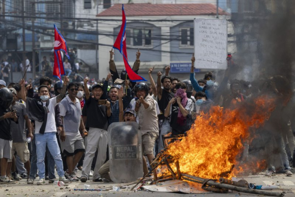 Protesters clash with police in front of the parliament building in Kathmandu, Nepal, Monday. Young demonstrators gathered in the capital to demand an end to corruption and the lifting of social media bans. The government shut down platforms, including Facebook, YouTube, Instagram, and WhatsApp, after they refused to register in Nepal. Photo by Narendra Shrestha/EPA