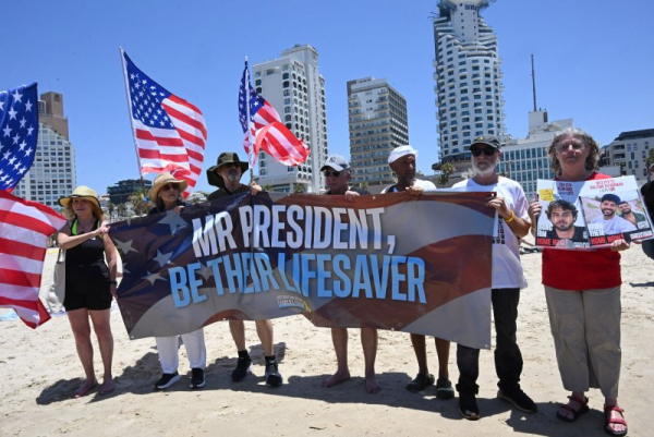 Protesters are pictured in July holding a banner calling on U.S. President Donald Trump to be the lifesaver of Israeli hostages still held by Hamas in Gaza since October 7, 2023. File Photo by Debbie Hill/ UPI