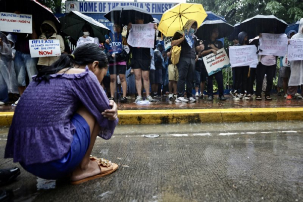 Filipinos protest outside a police station in Manila on Monday, calling for the release of protesters detained Sunday at a demonstration against government corruption, which they blame for a severe lack of flood control infrastructure that has resulted in some residents being inundated year-round. Photo by Francis R. Malasig/EPA