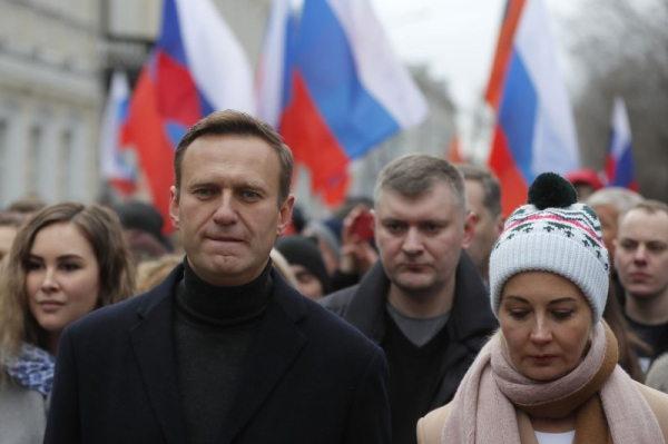 Russian opposition leader and anti-corruption activist Alexei Navalny walked alongside his wife Yulia Navalnaya as they took part in a memorial march for Boris Nemtsov marking the fifth anniversary of his assassination in Moscow in 2020. Wednesday, Navalnaya announced that labs confirmed Navalny had been poisoned before he died. File Photo Yuri Kochetkov/EPA