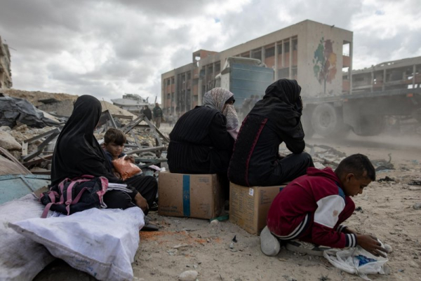 Palestinians wait for aid trucks in Khan Yunis in the southern Gaza Strip on Sunday. Photo by Haitham Imad/EPA
