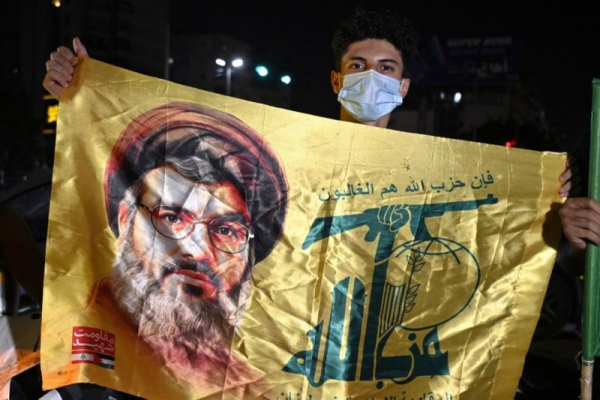 A supporter holds a Hezbollah flag during a rally to protest against the Lebanese government's endorsement of a plan to disarm the militant group, in a southern suburb of Beirut, Lebanon, in early September. File Photo by Wael Hamzeh/EPA