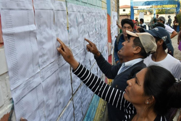 Citizens check for their polling station at a voting center in Entre Rios, Bolivia, on August 17 to elect a new government and parliament for the next five years. A presidential runoff is scheduled for October 19. File Photo by Jorge Abrego/EPA