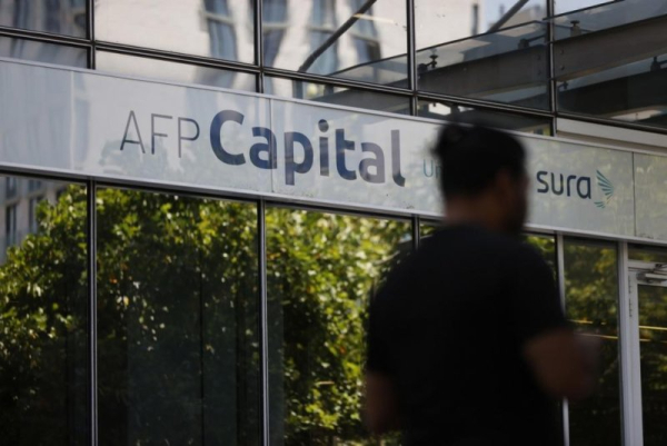 A man walks in front of a branch of the Pension Fund administrator in Santiago, Chile, in January. Parliament approved pension reform promoted by Gabriel Boric's government. File Photo by Elvis Gonzalez