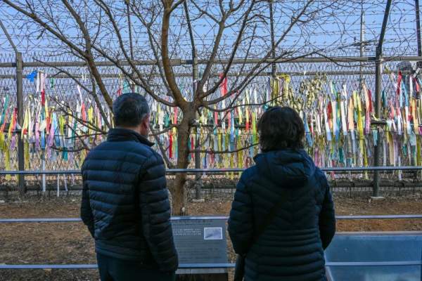 Fewer than half of South Koreans believe unification with the North is necessary, according to a survey released Monday. In this 2021 photo, visitors at Imjingak Park near the DMZ look at ribbons expressing wishes for unification. File Photo by Thomas Maresca/UPI