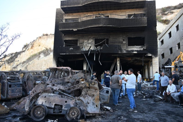 People inspect the damage following an Israeli strike in the Msaileh area in southern Lebanon early Saturday, which the IDF said targeted sites where Iran-backed Hezbollah was reestablishing 