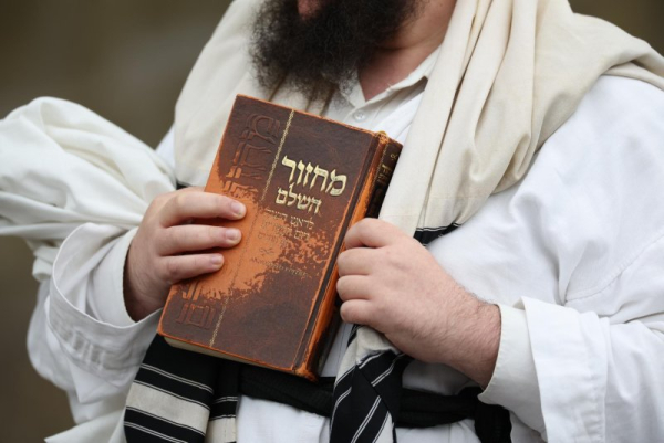 A member of the Jewish community stands at a police cordon in Manchester, England, Thursday. Two people have died after a car and stabbing attack at a synagogue in Manchester, with the suspect shot by police. Photo by Adam Vaughan/EPA