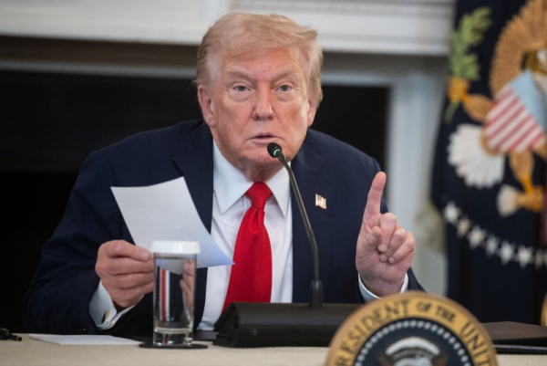President Donald Trump holds a noted given to him by Secretary of State Marco Rubio about peace talks involving Israel and Hamas during a roundtable about antifa in the State Dining Room at the White House on Wednesday. Photo by Francis Chung/UPI