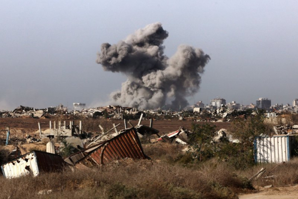 A plume of smoke rises above Gaza City during an Israeli strike on Friday, and Israel's military continued its offensive in Gaza City on Saturday, but it might withdraw amid a possible cease-fire with Hamas. Pool Photo by Jack Guez/UPI