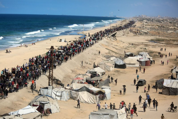 Thousands of displaced Palestinians walk along the Rashid coastal road toward Gaza City following the implementation of the cease-fire, in the central Gaza Strip on Friday. Photo by Hassan Al-Jadi/UPI