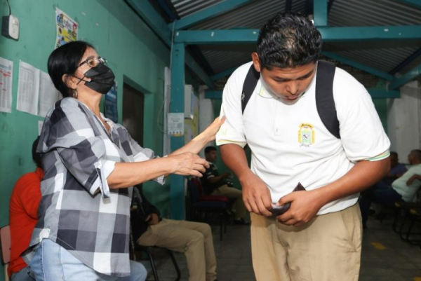 A school staff member checks a student at Instituto Nacional Maestro Alberto Masferrer in San Salvador, El Salvador, on August 20. El Salvador's Minister of Education, Karla Trigueros, issued 