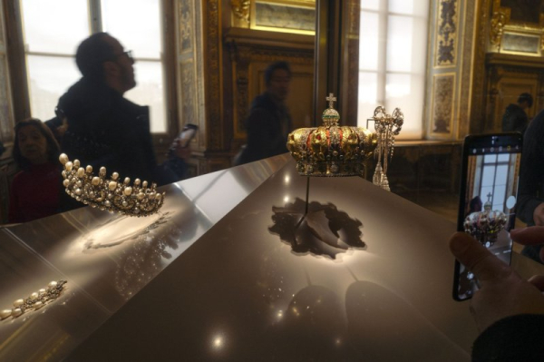 Museum goers are pictured at the Louvre in the golden room which holds the French Crown Jewels, some of which were stolen during a daylight robbery on Sunday morning. File Photo by Jim Hollander/UPI